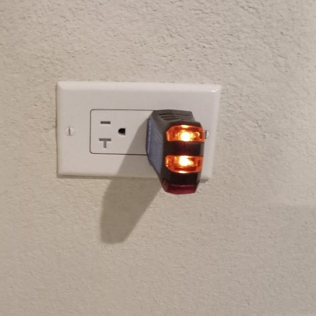 Wall outlet with plug-in light